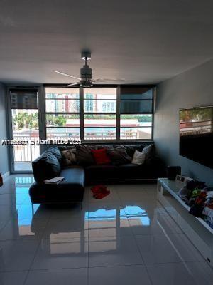 a living room with furniture and a floor to ceiling window