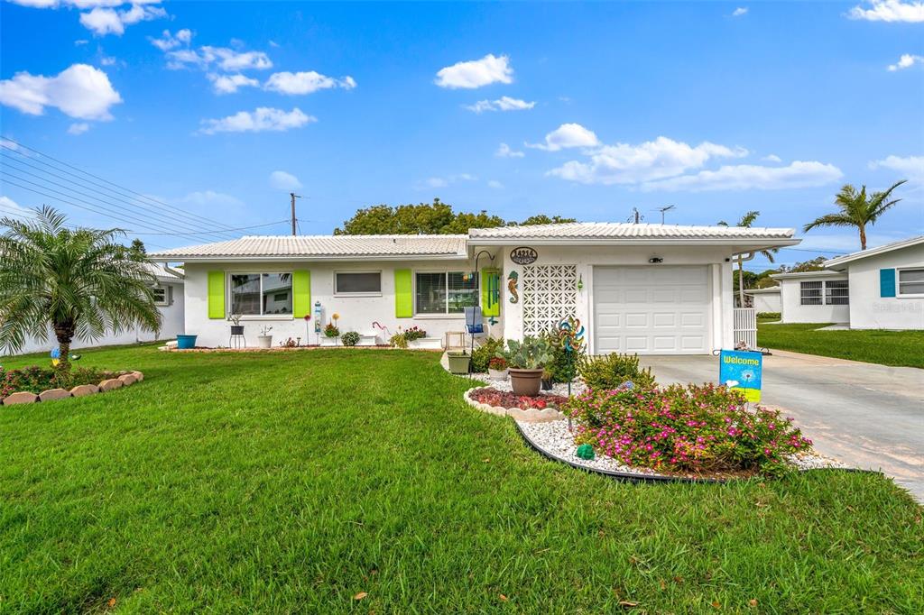 a view of a house with a swimming pool and a yard