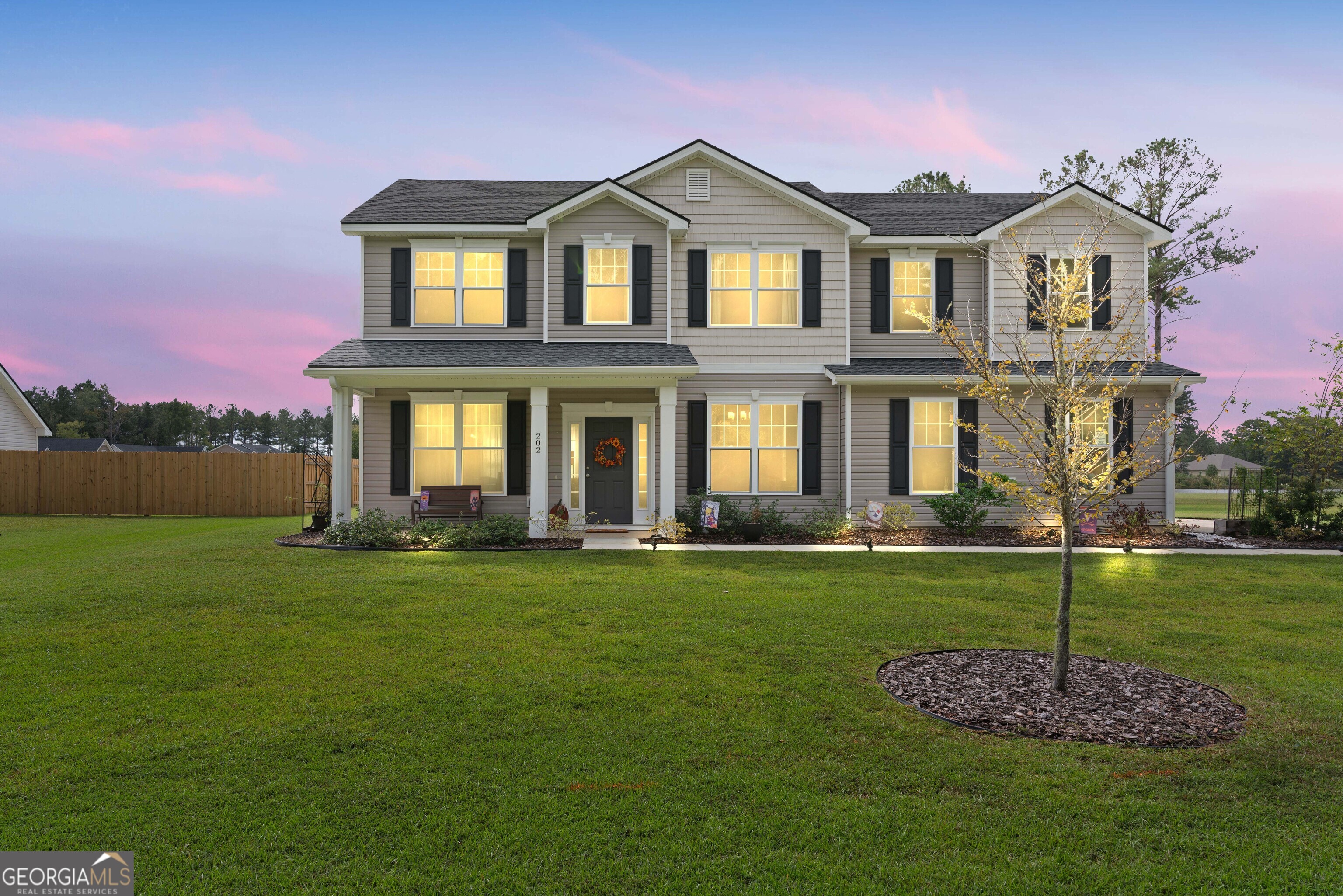 a front view of a house with a yard