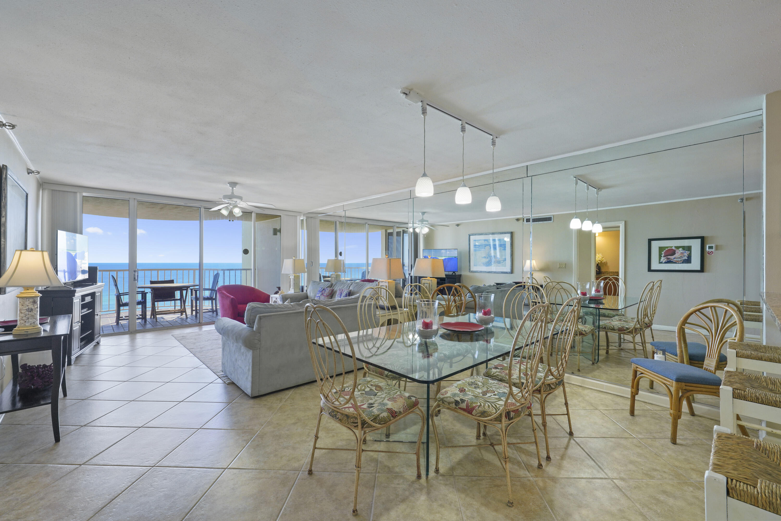 a living room with furniture and a dining table with wooden floor