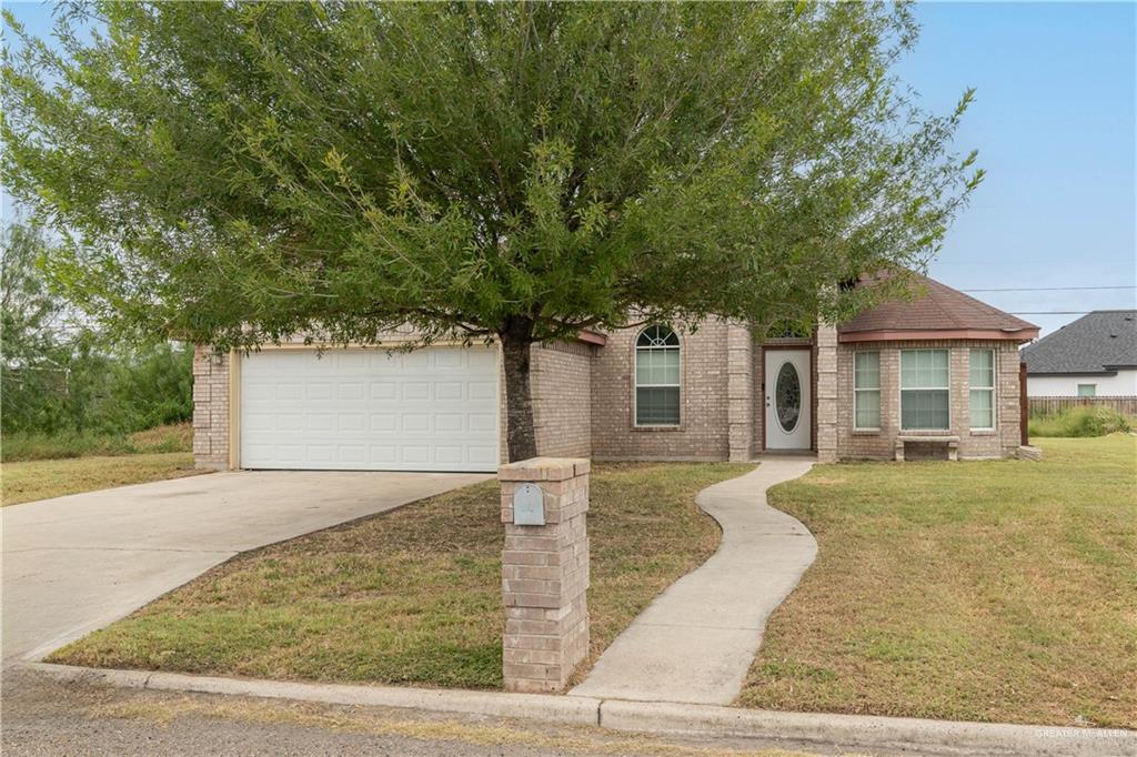 View of front of property with a garage and a front yard