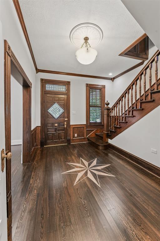 Fantastic entryway with custom stained star, chandelier and stairway.