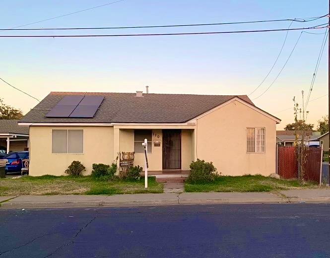 a front view of a house with a yard and a garage