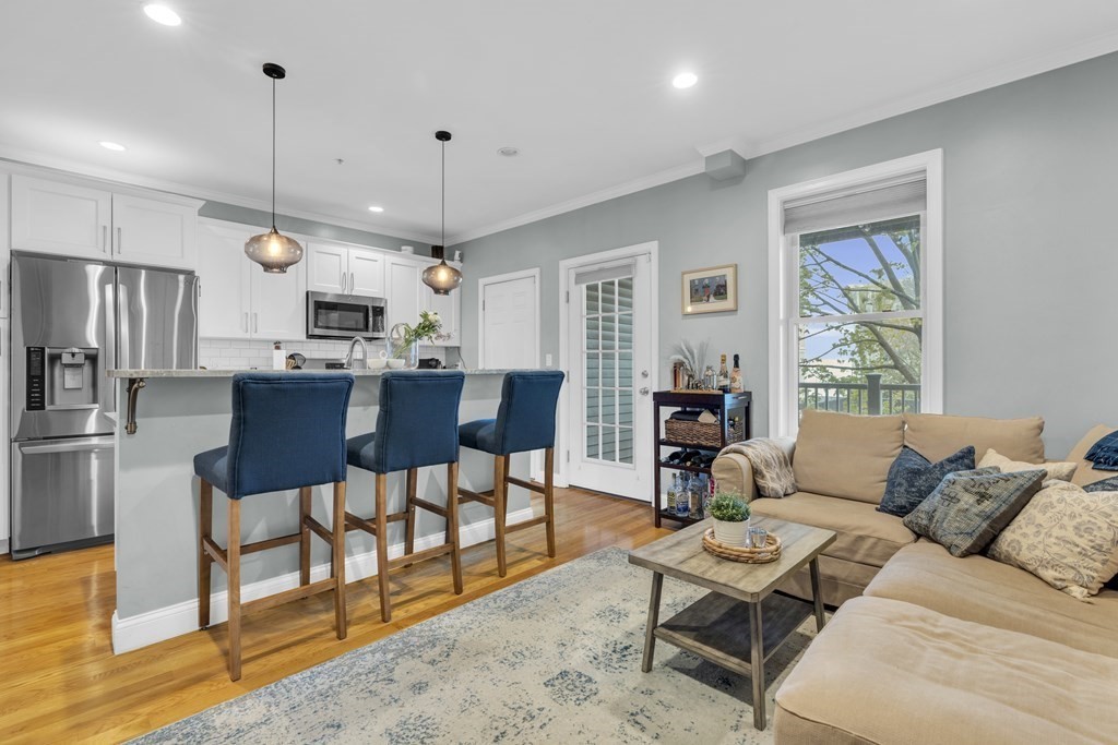 a living room with furniture a dining table and kitchen view