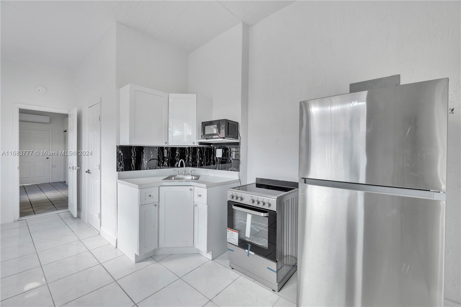 a kitchen with stainless steel appliances a refrigerator sink and cabinets