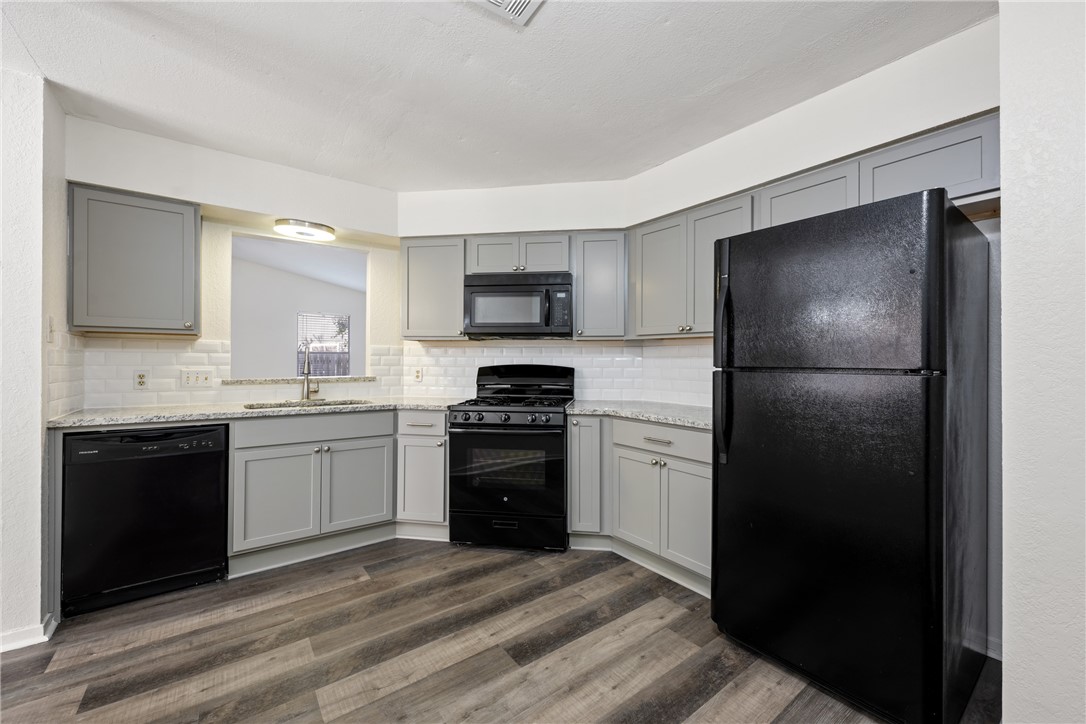 a kitchen with a refrigerator stove and sink