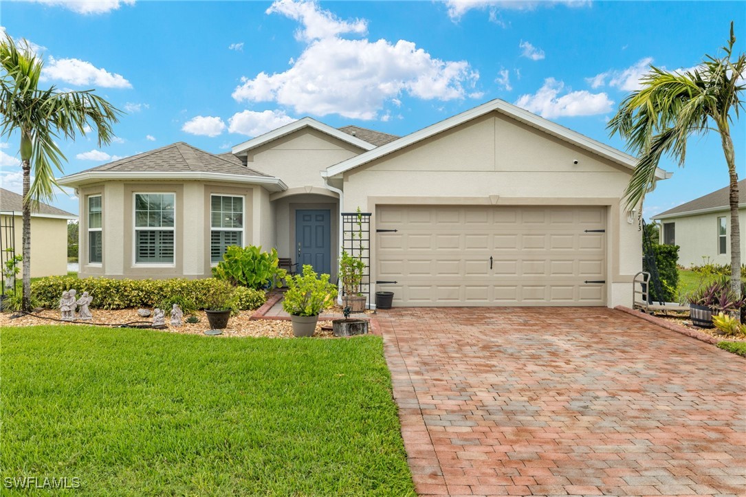 a front view of a house with a yard and garage