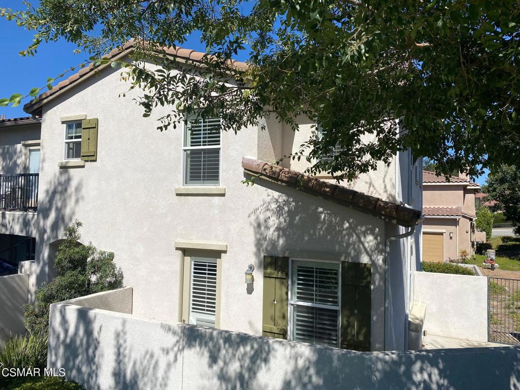 a front view of a house with a tree