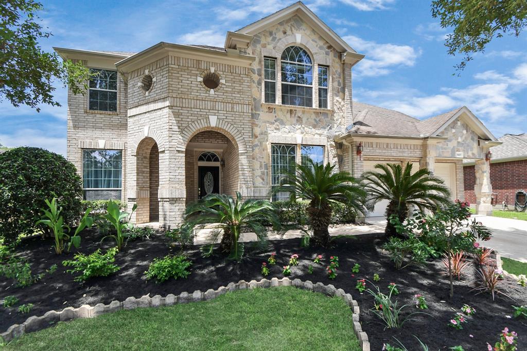 a front view of a house with a garden