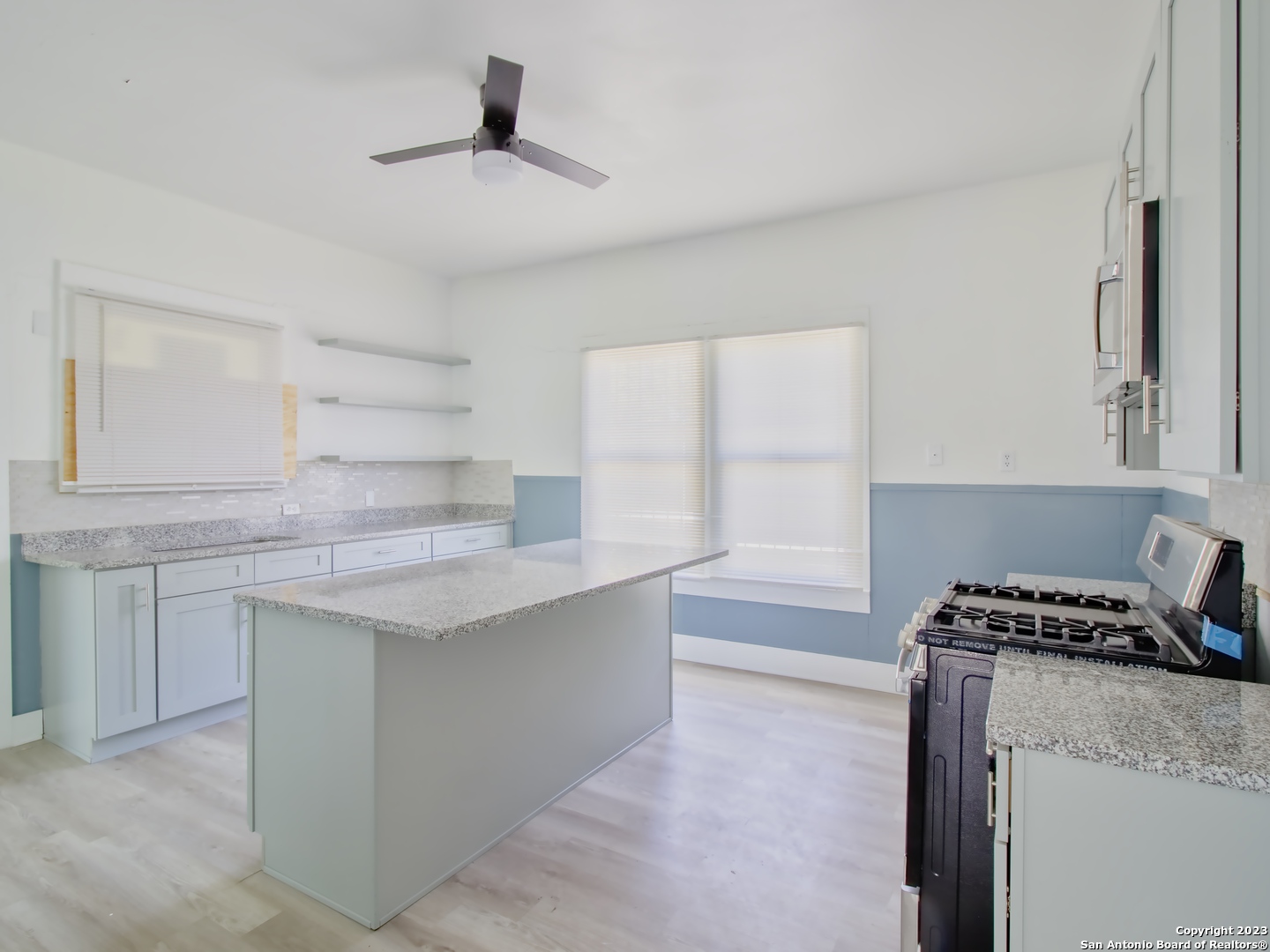 a kitchen with granite countertop a sink and a stove