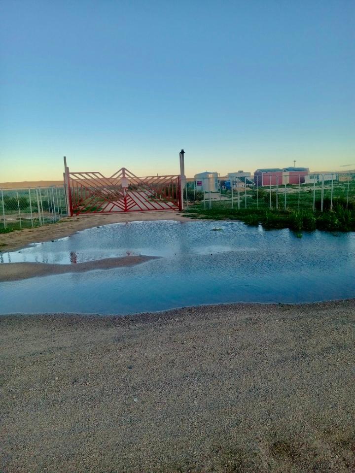 a view of a road with a house in the background