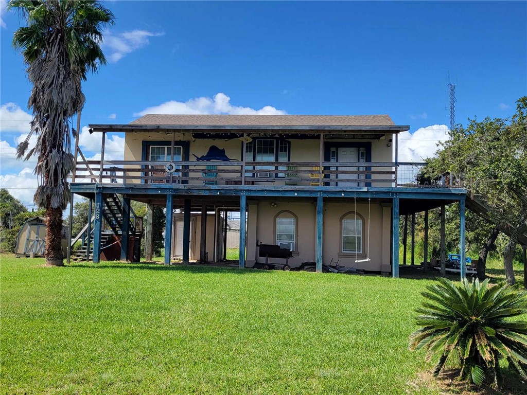 a view of a house with a swimming pool and a yard