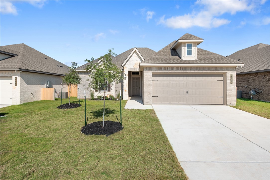 View of front of property with a front lawn and a