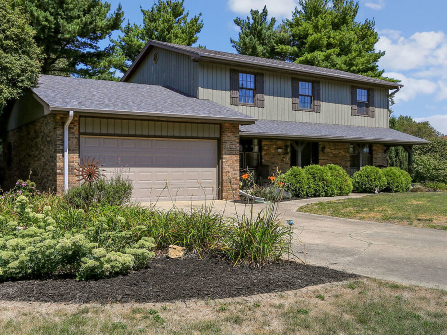 a front view of a house with a garden