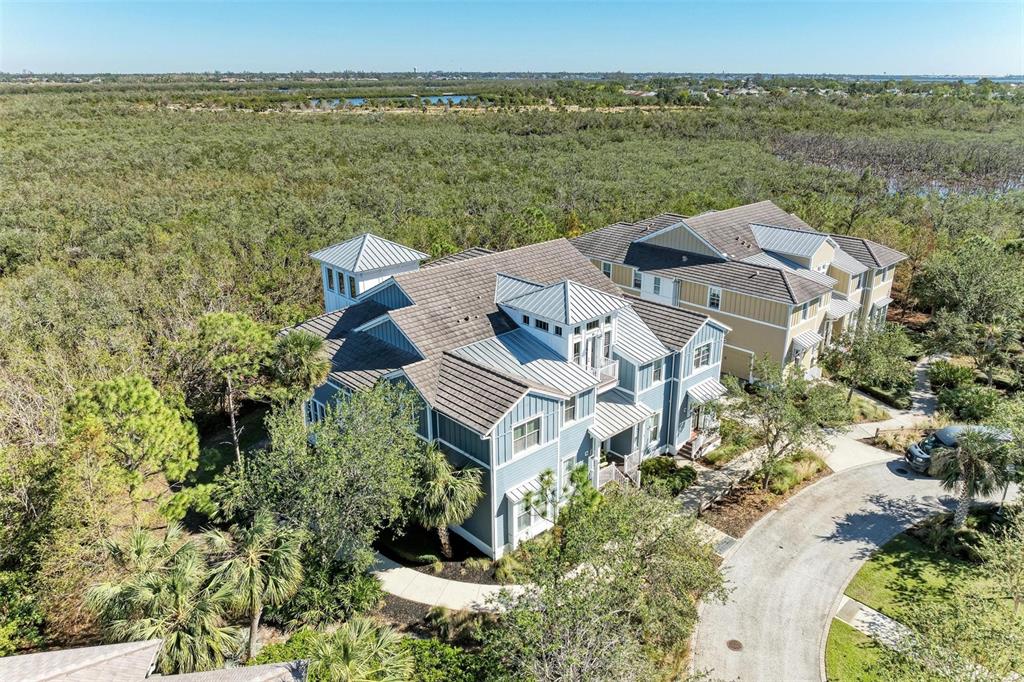 an aerial view of a house with a garden and lake view