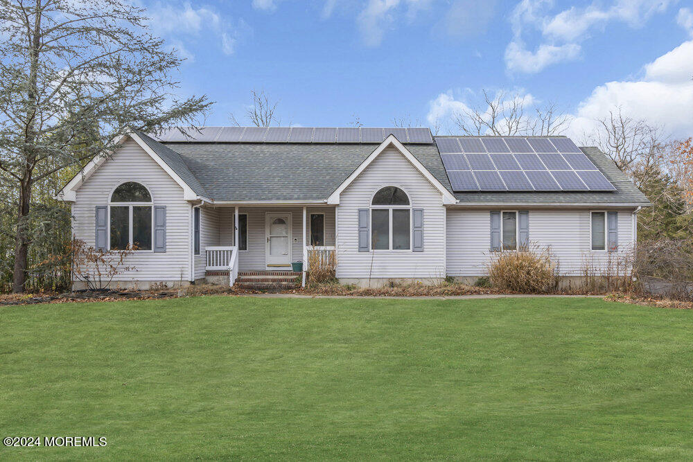 a front view of a house with a garden