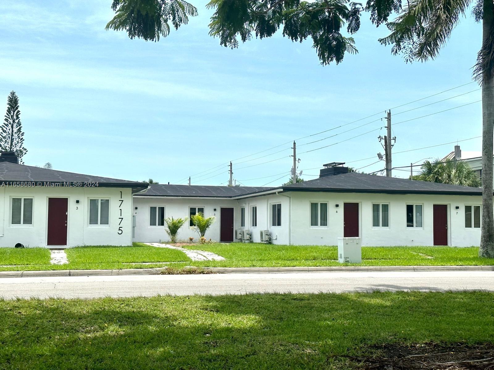 a front view of a house with a garden and yard