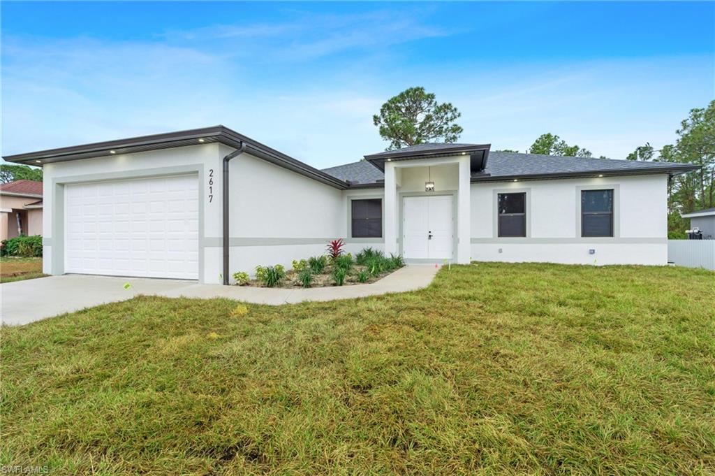 a view of a house with a yard and garage