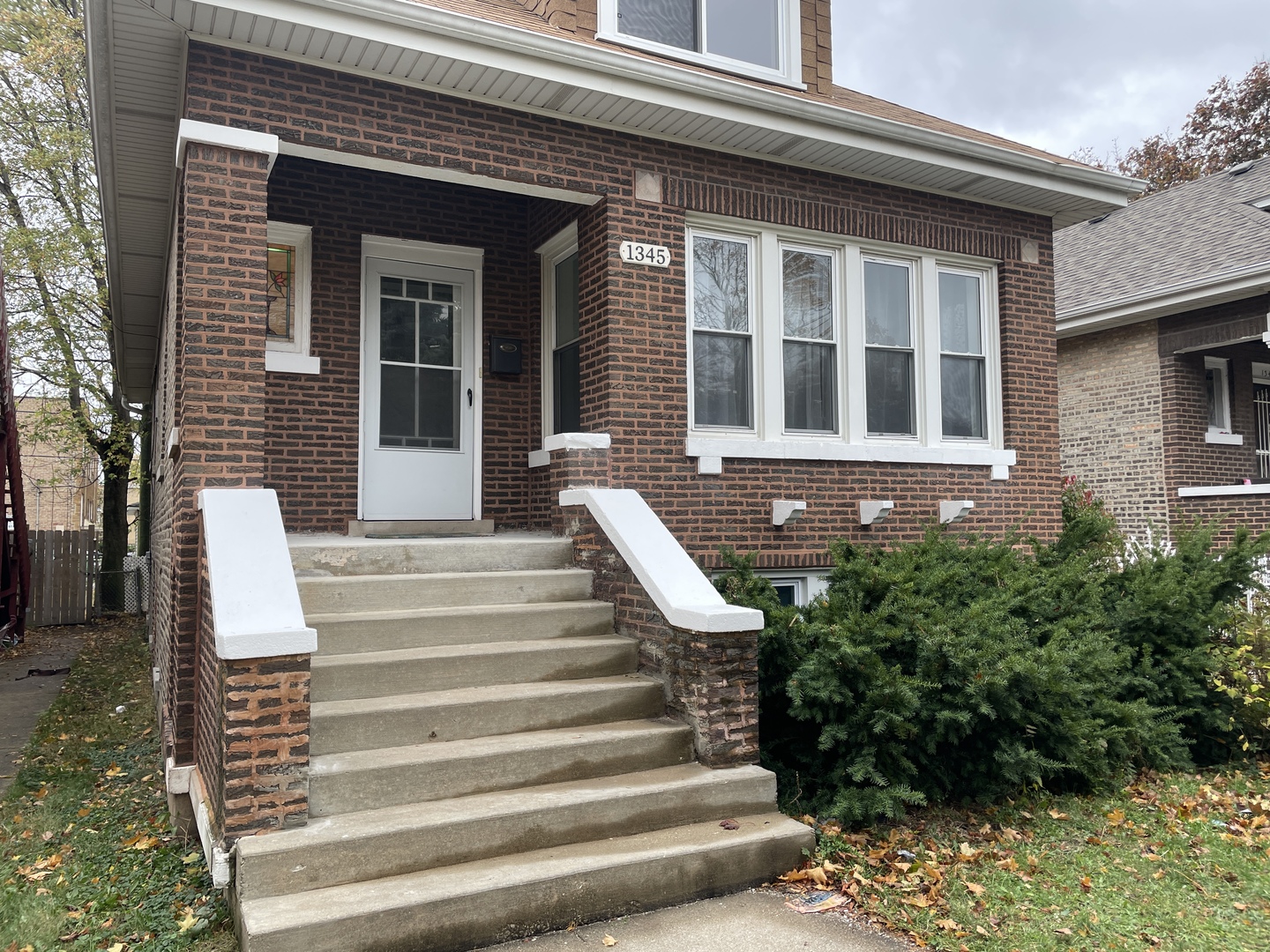 a view of a house with large windows and stairs