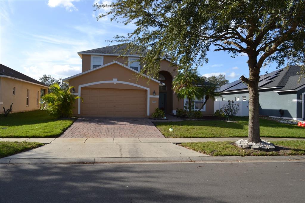 a front view of a house with a yard and garage