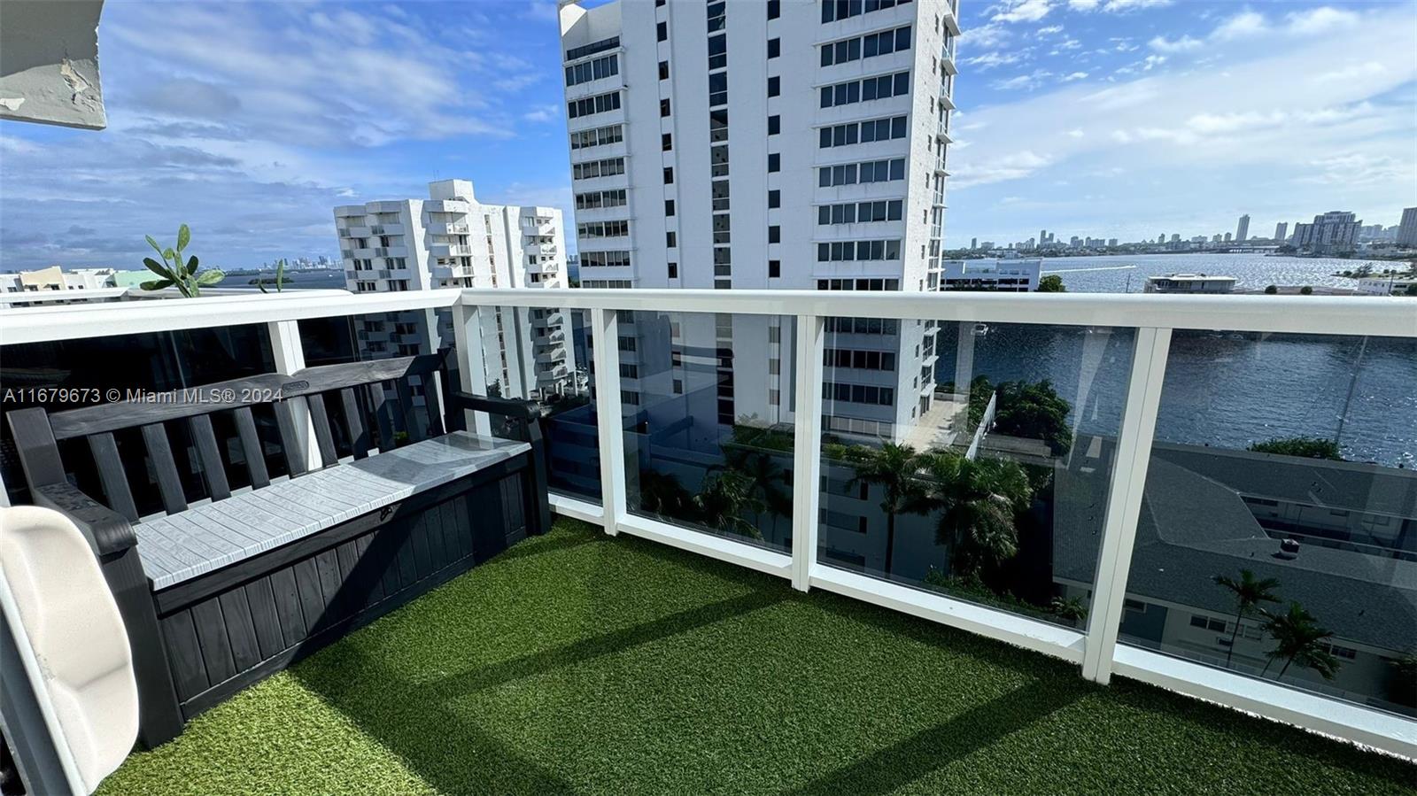 a view of a balcony with an outdoor seating