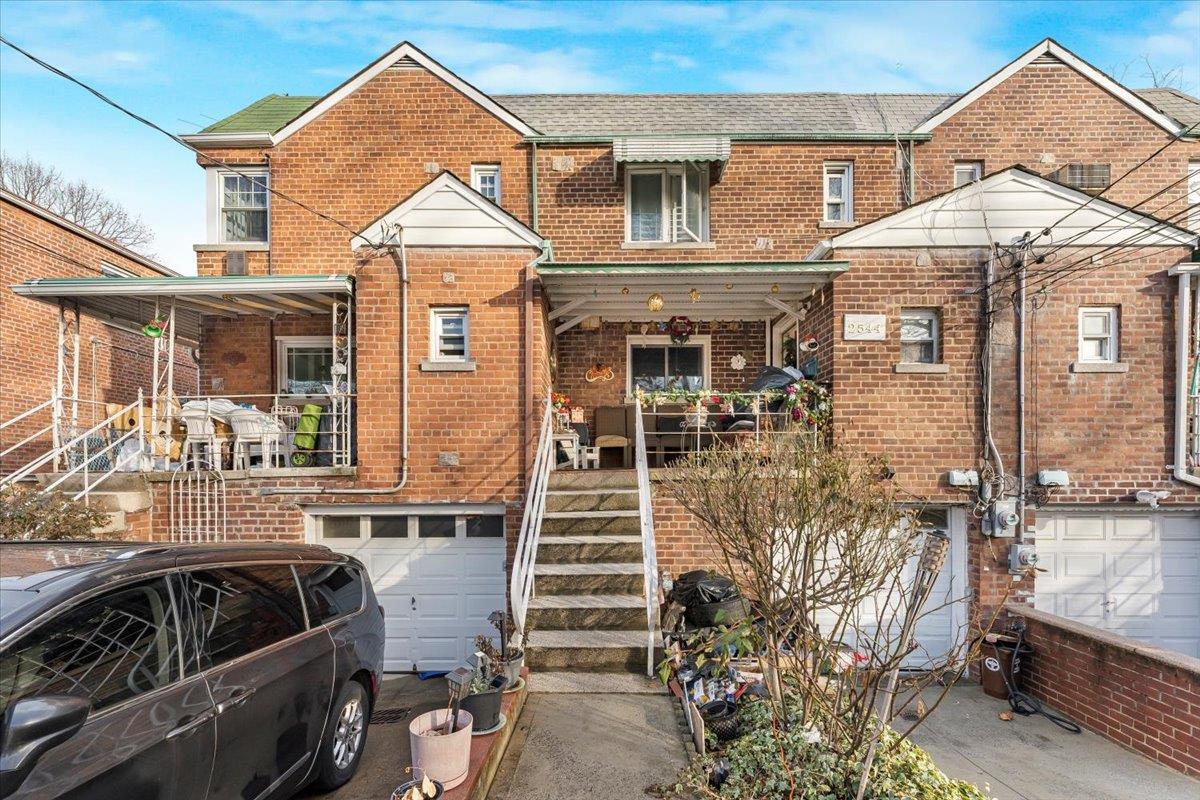 View of front of house featuring a porch and a garage