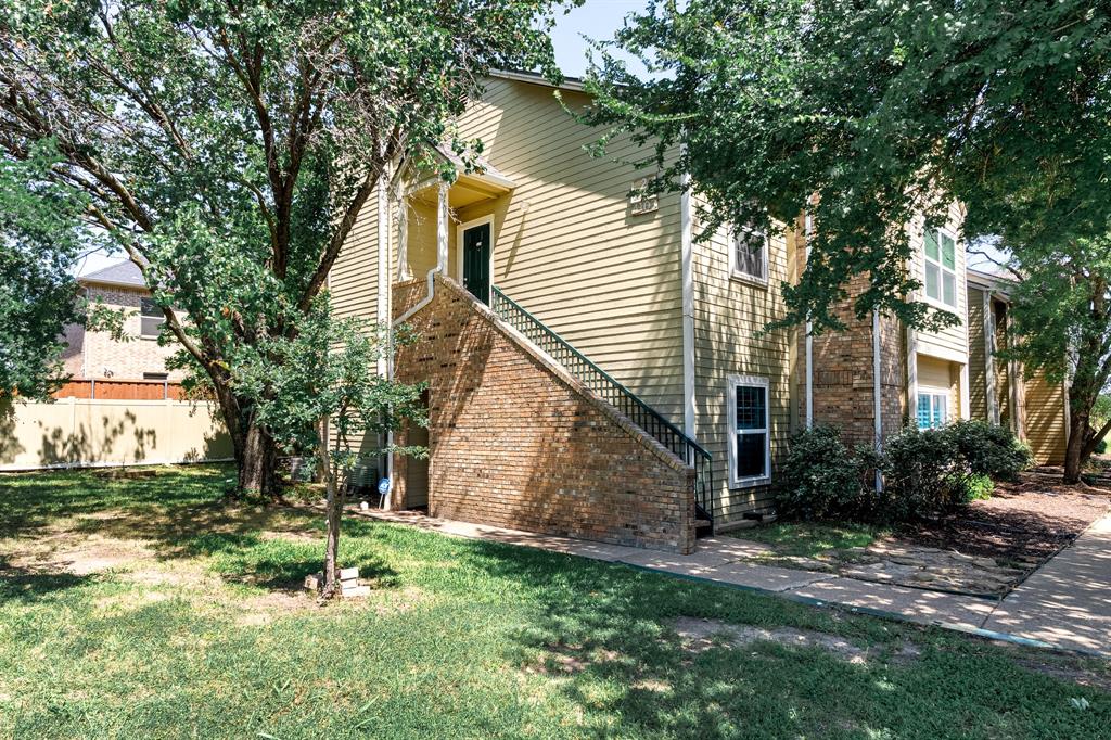 a view of backyard of house with green space