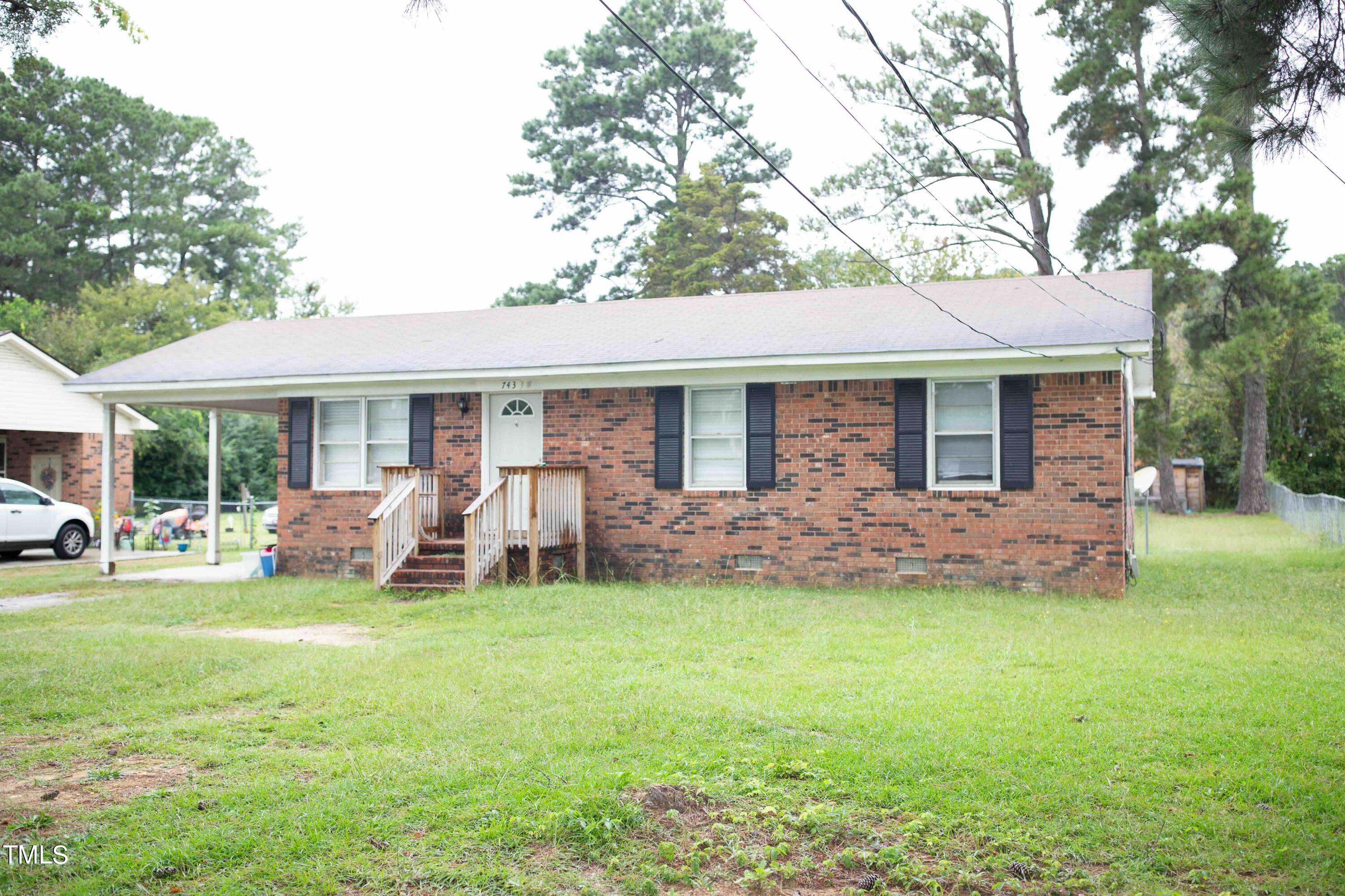 a view of a house with a yard and sitting area