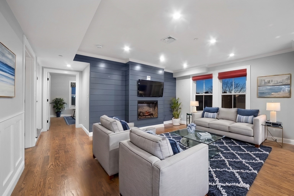 a living room with furniture fireplace and a flat screen tv