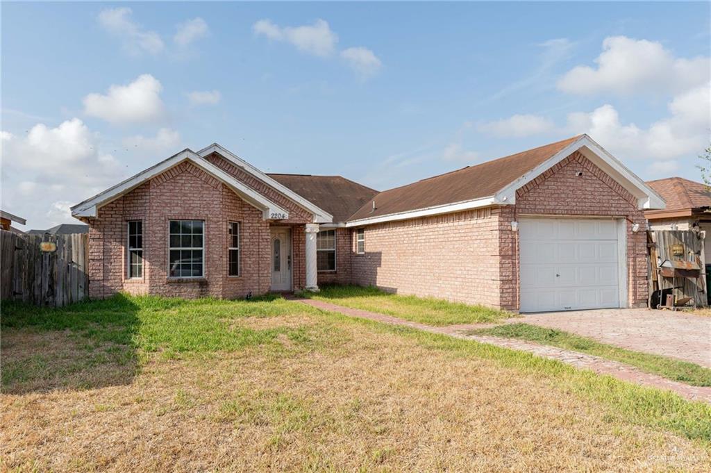 a view of a house with a yard and garage