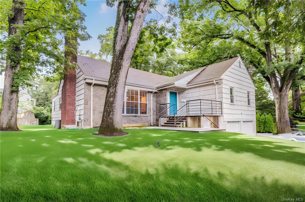 View of front of property with a garage and a front yard