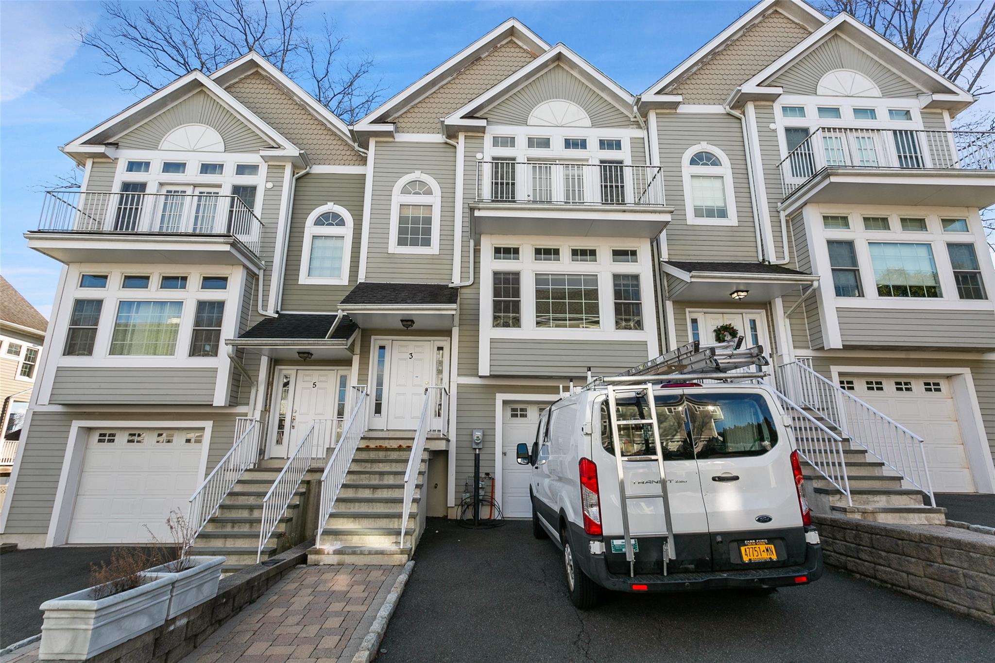 a view of a white house with a street