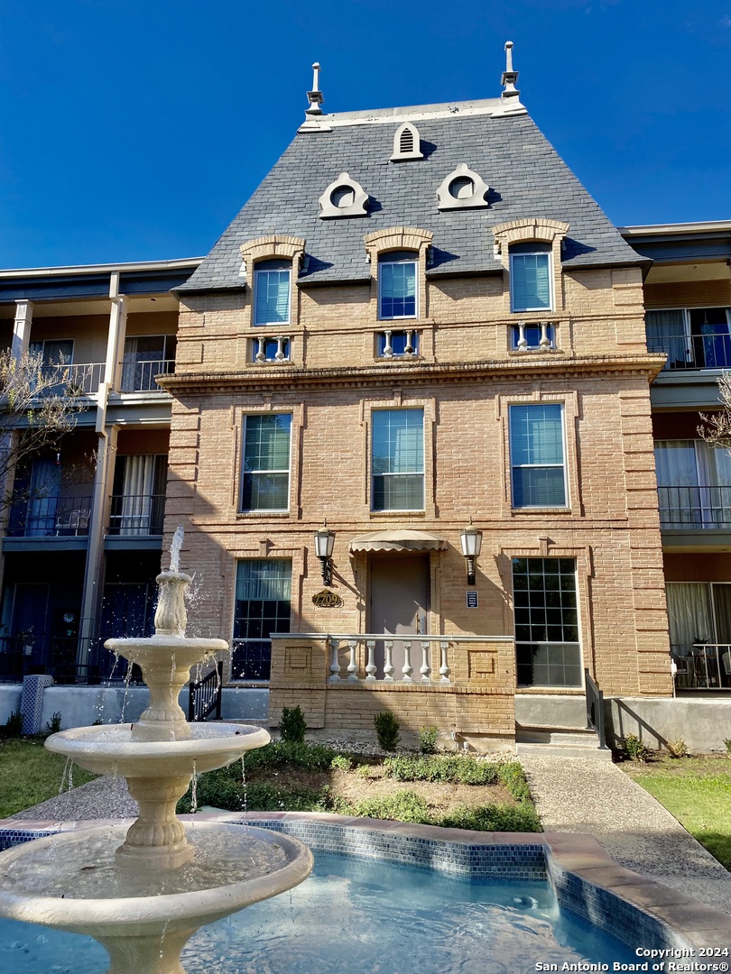 front view of a building with a fountain