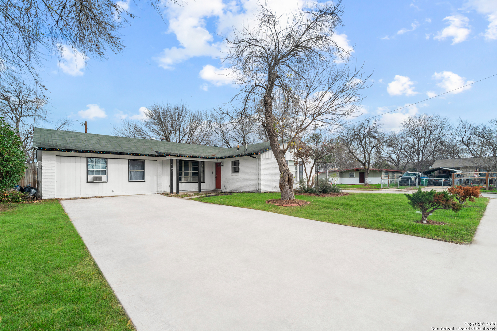 a front view of house with yard and green space