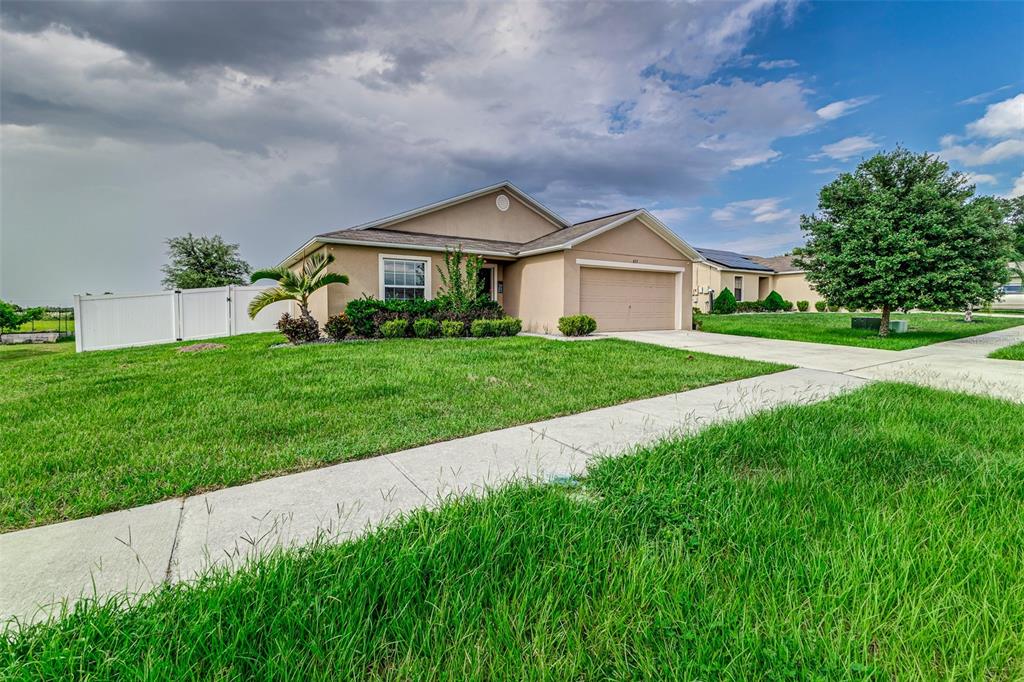 a front view of a house with a yard and garage