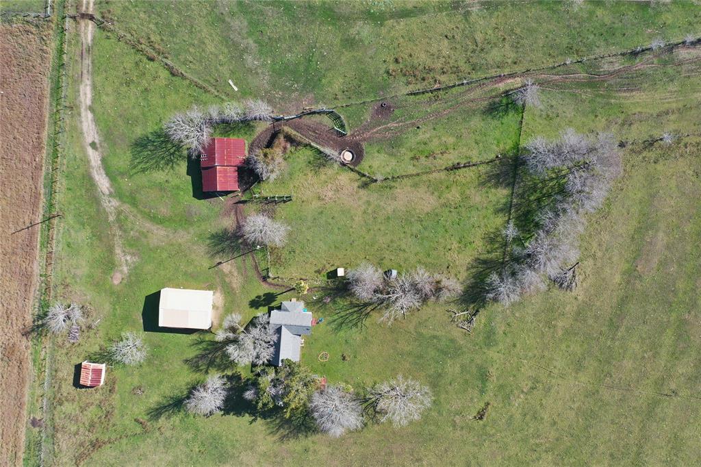 an aerial view of a house with a yard