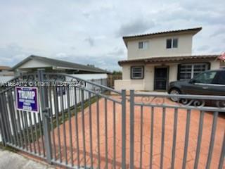 a view of a house with wooden fence