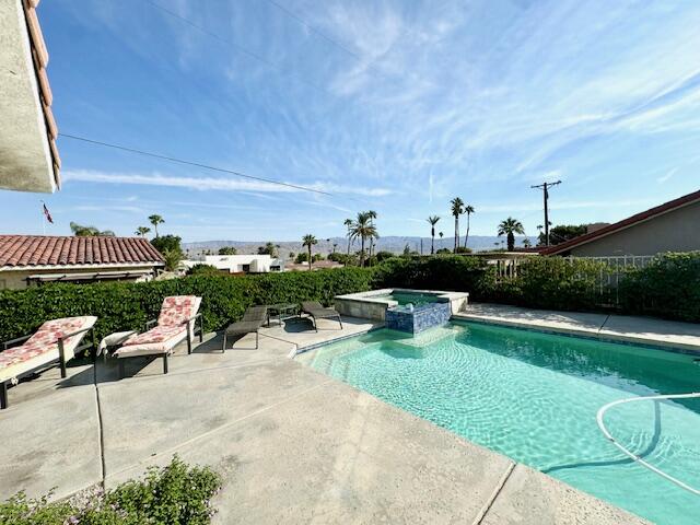 a view of a swimming pool and lounge chairs