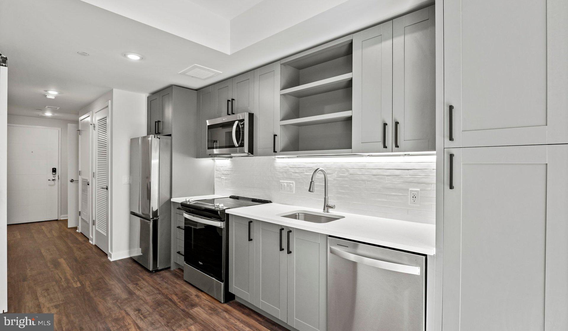 a kitchen with a sink appliances and cabinets