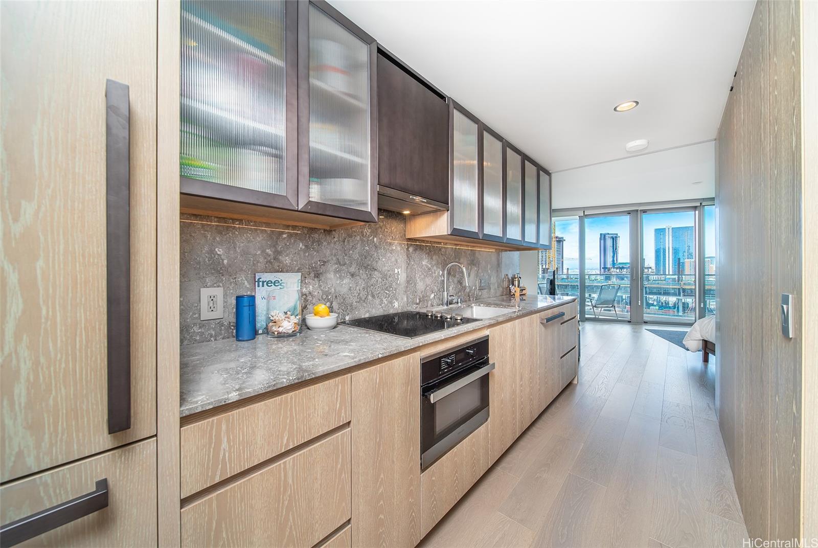 a kitchen with stainless steel appliances granite countertop a stove a sink and a refrigerator