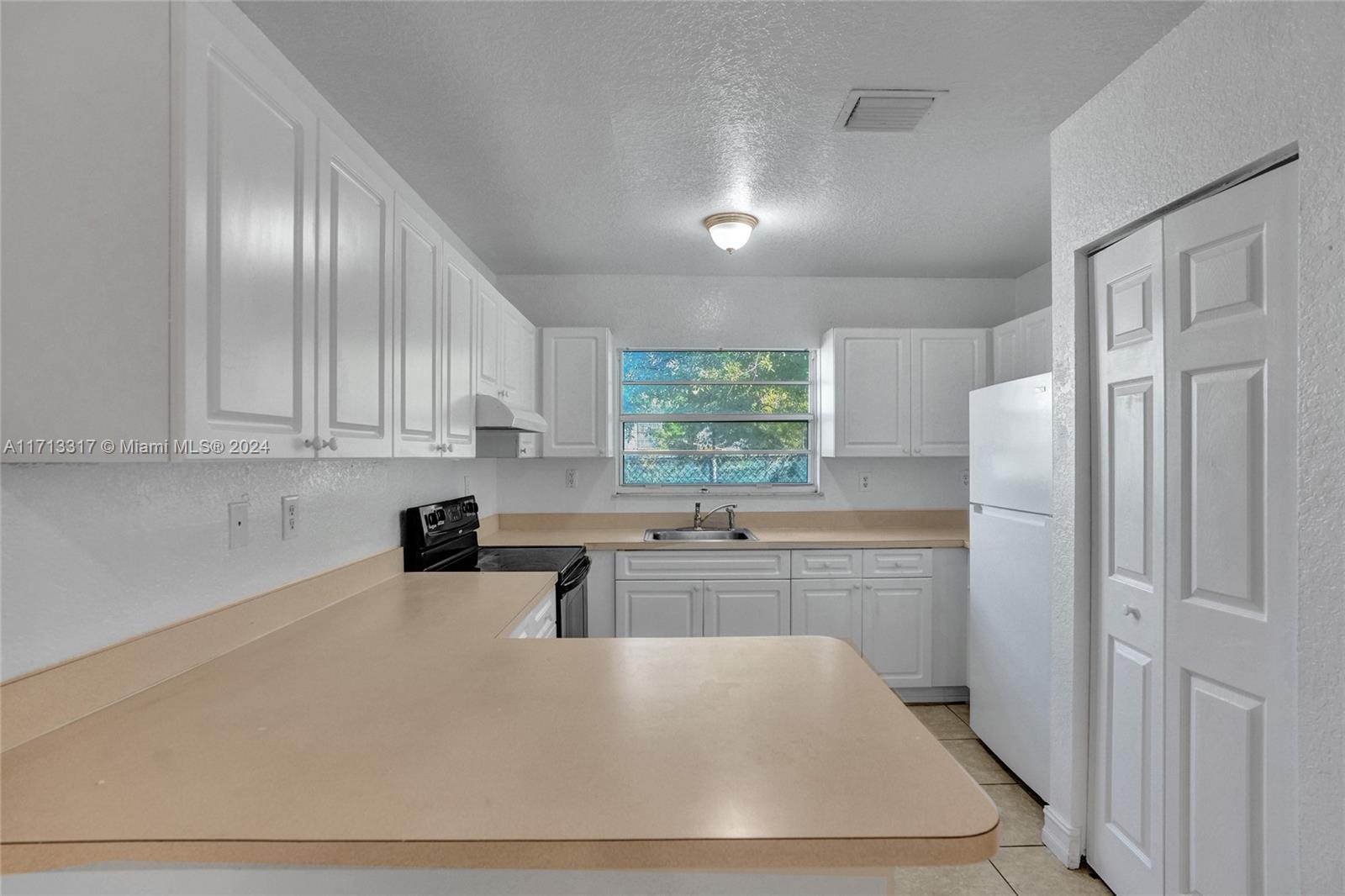 a kitchen with stainless steel appliances granite countertop a refrigerator sink and cabinets