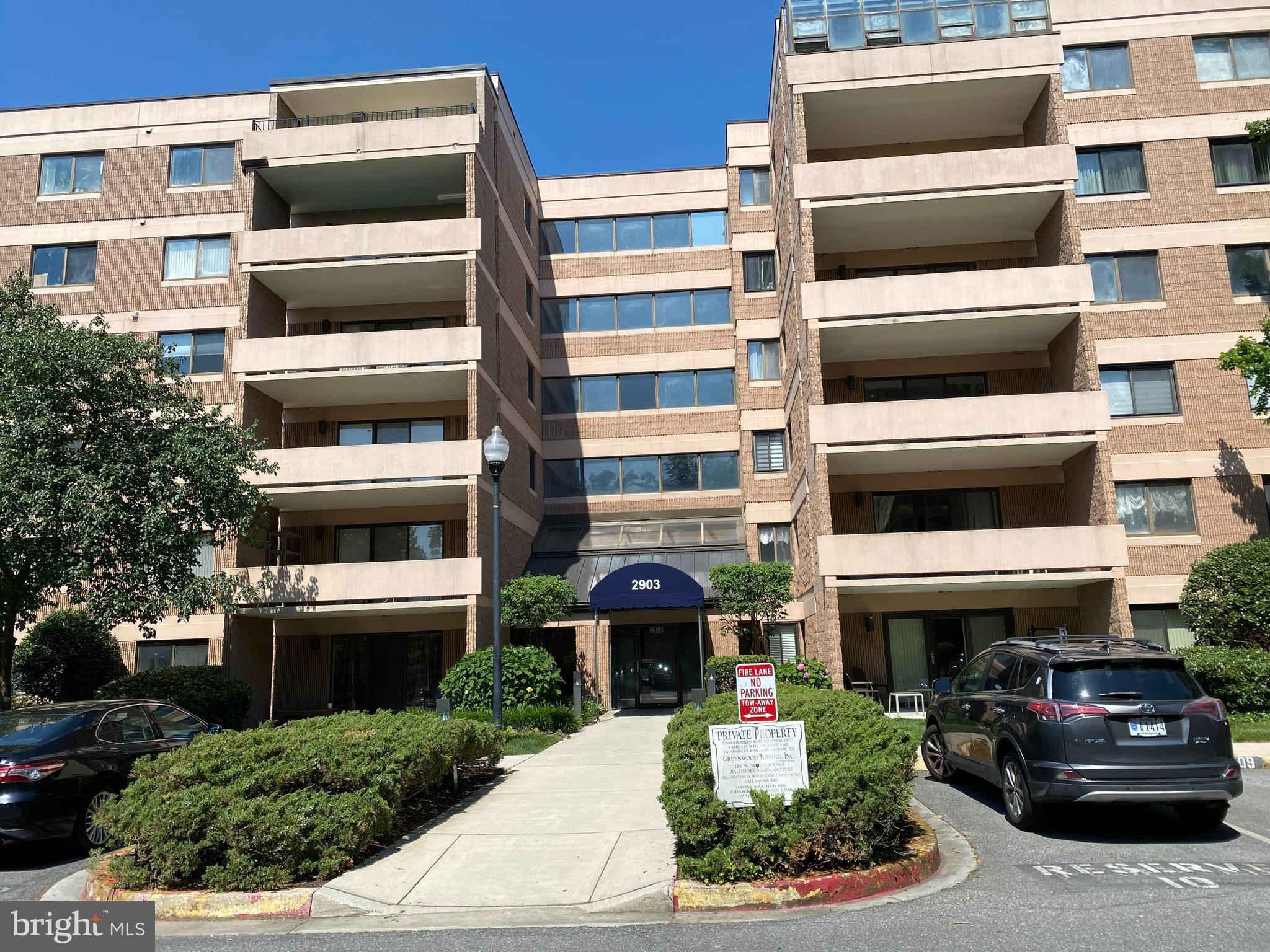 a front view of a building with a yard