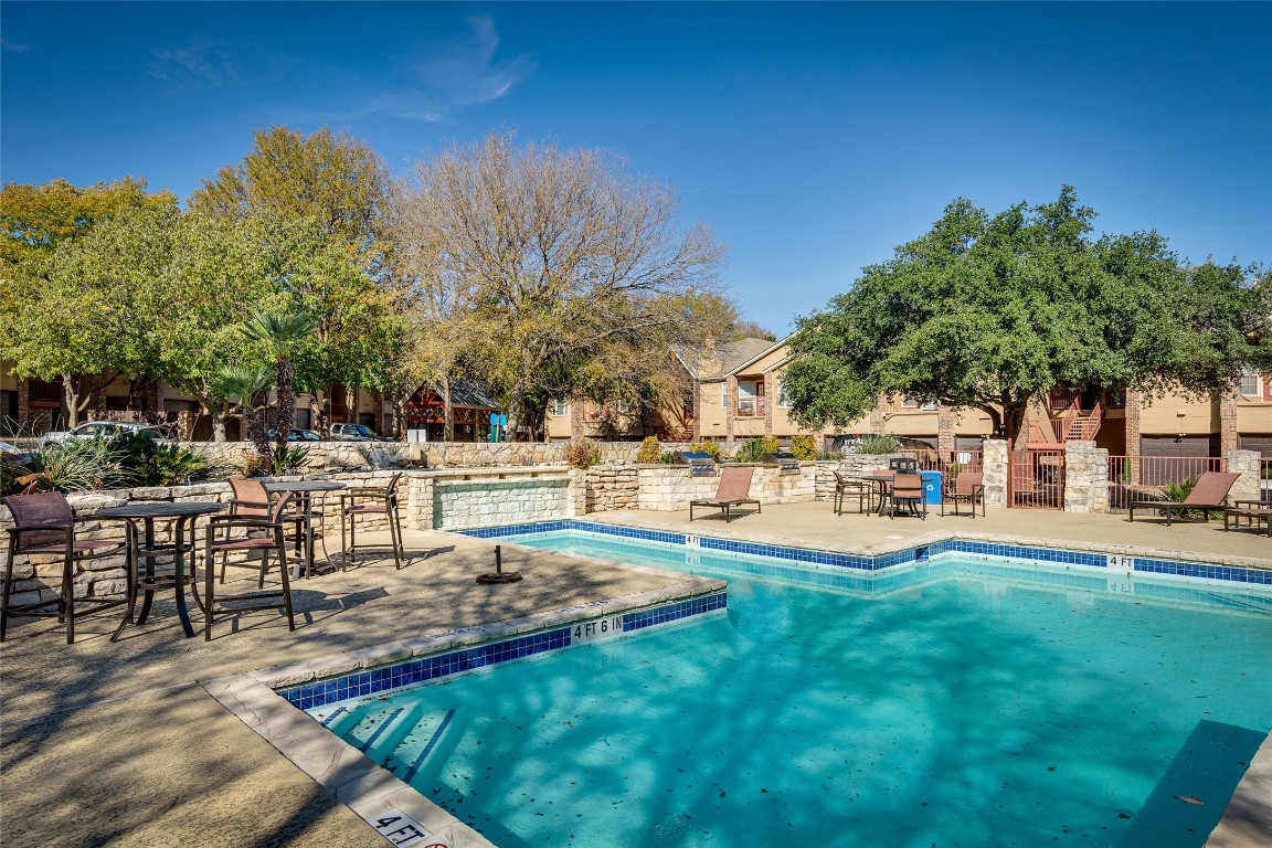 a swimming pool with outdoor seating and yard