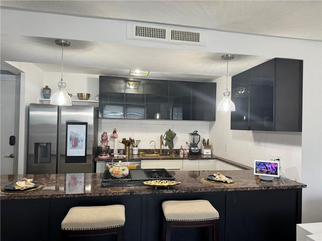 a kitchen with a table and chairs in it