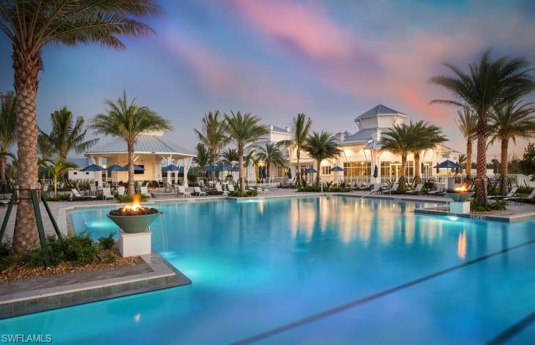 a view of swimming pool with outdoor seating and lake view