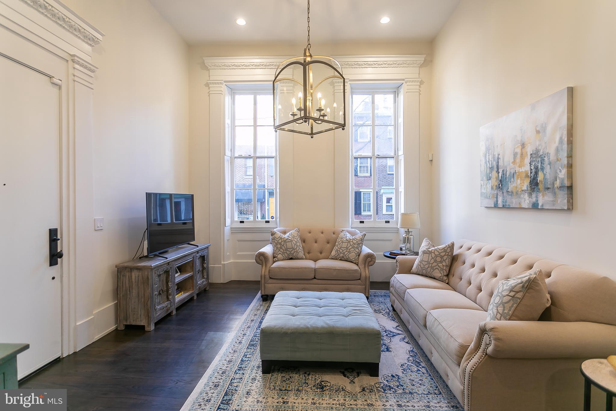 a living room with furniture fireplace and flat screen tv