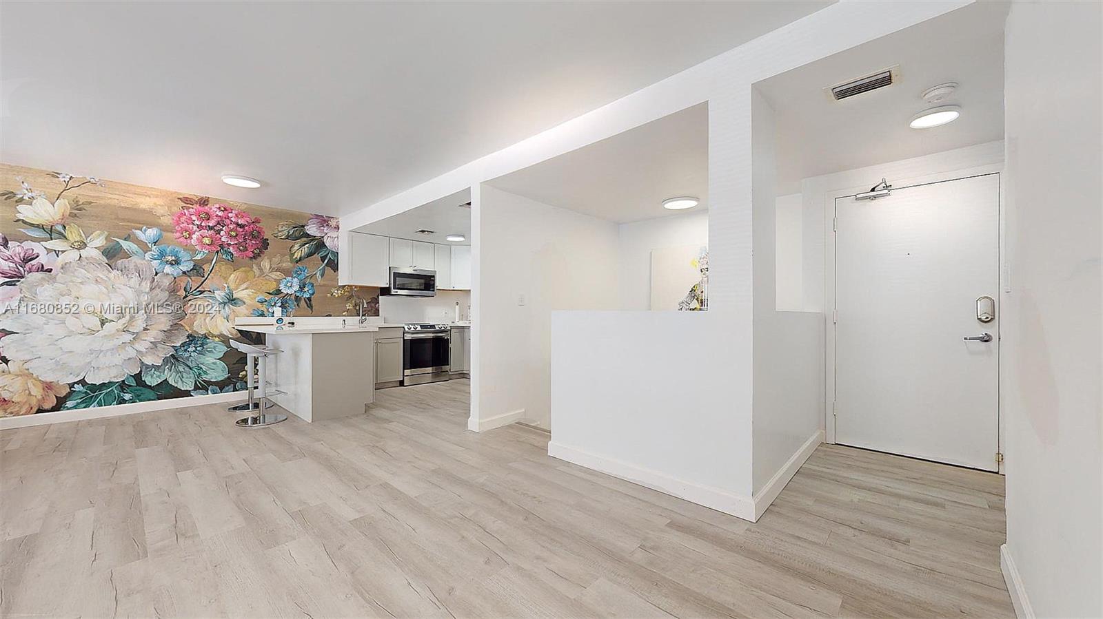 a view of a kitchen with wooden floor