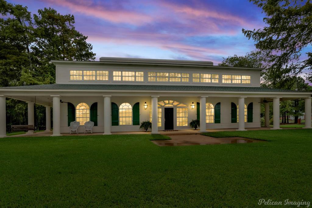 a front view of a building with a garden