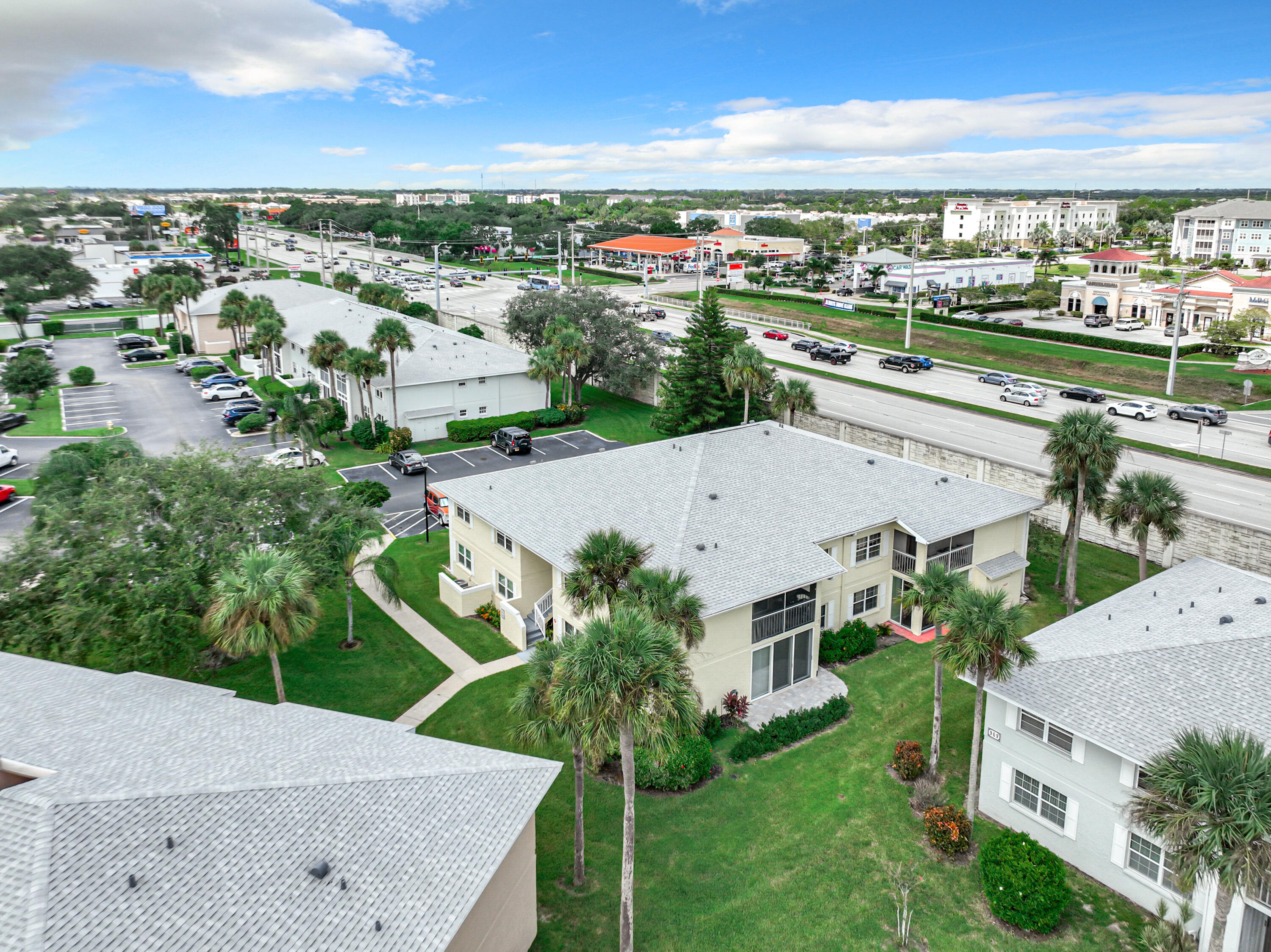 an aerial view of residential houses with outdoor space and ocean view