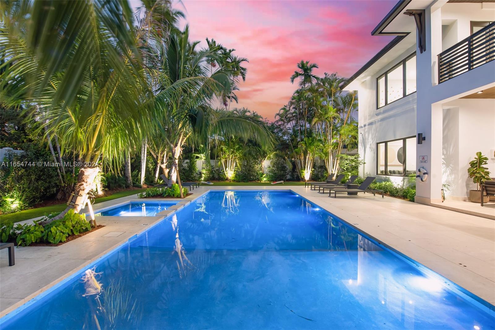 a swimming pool with outdoor seating and yard